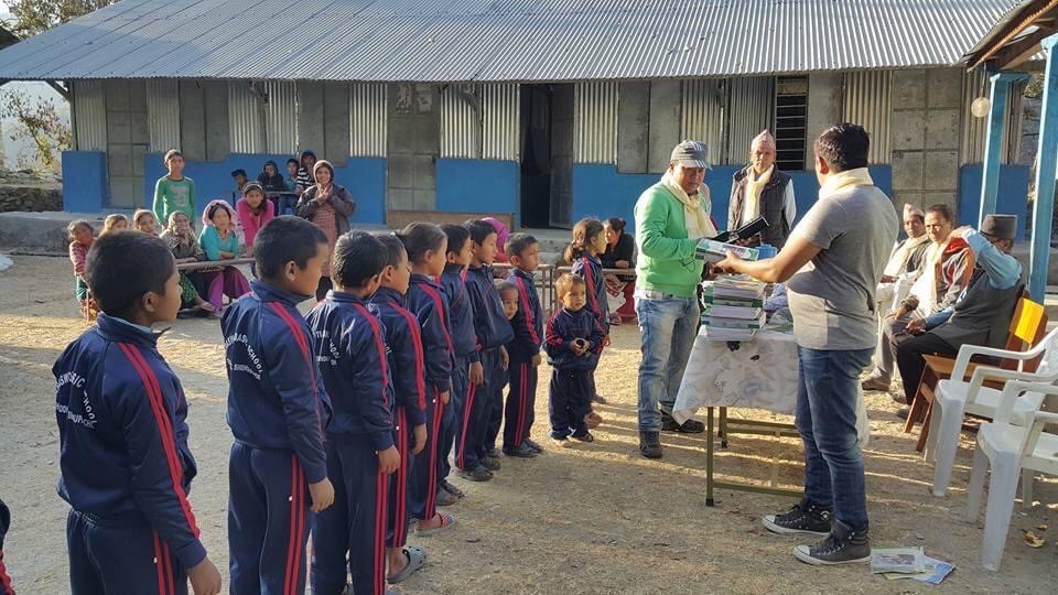 Providing school supplies at a village school in Lisank